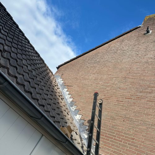 Roof with ladder and blue sky background.